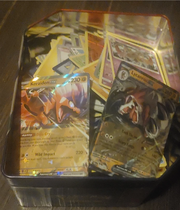 Bunch of random Pokémon Trading Card Game Tin Bundle has lid