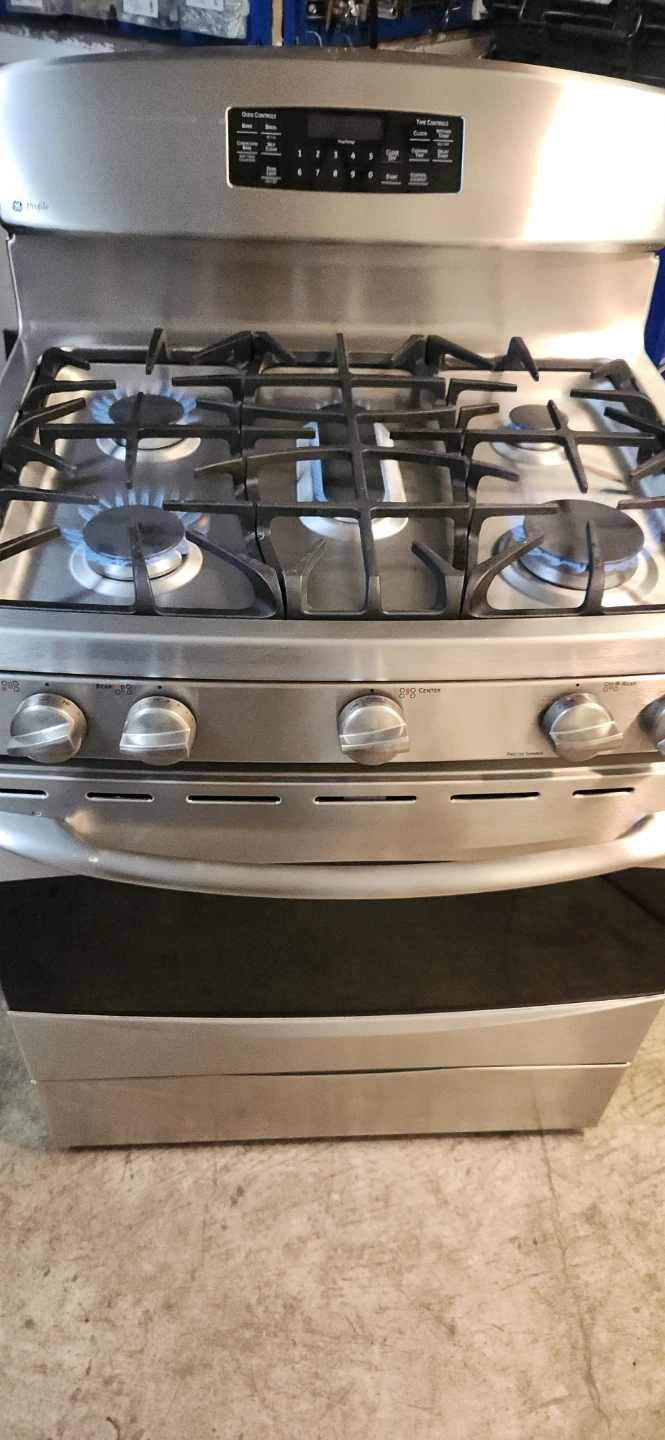 GE Stainless Steel Gas Range and whirlpool Microwave Oven Combo