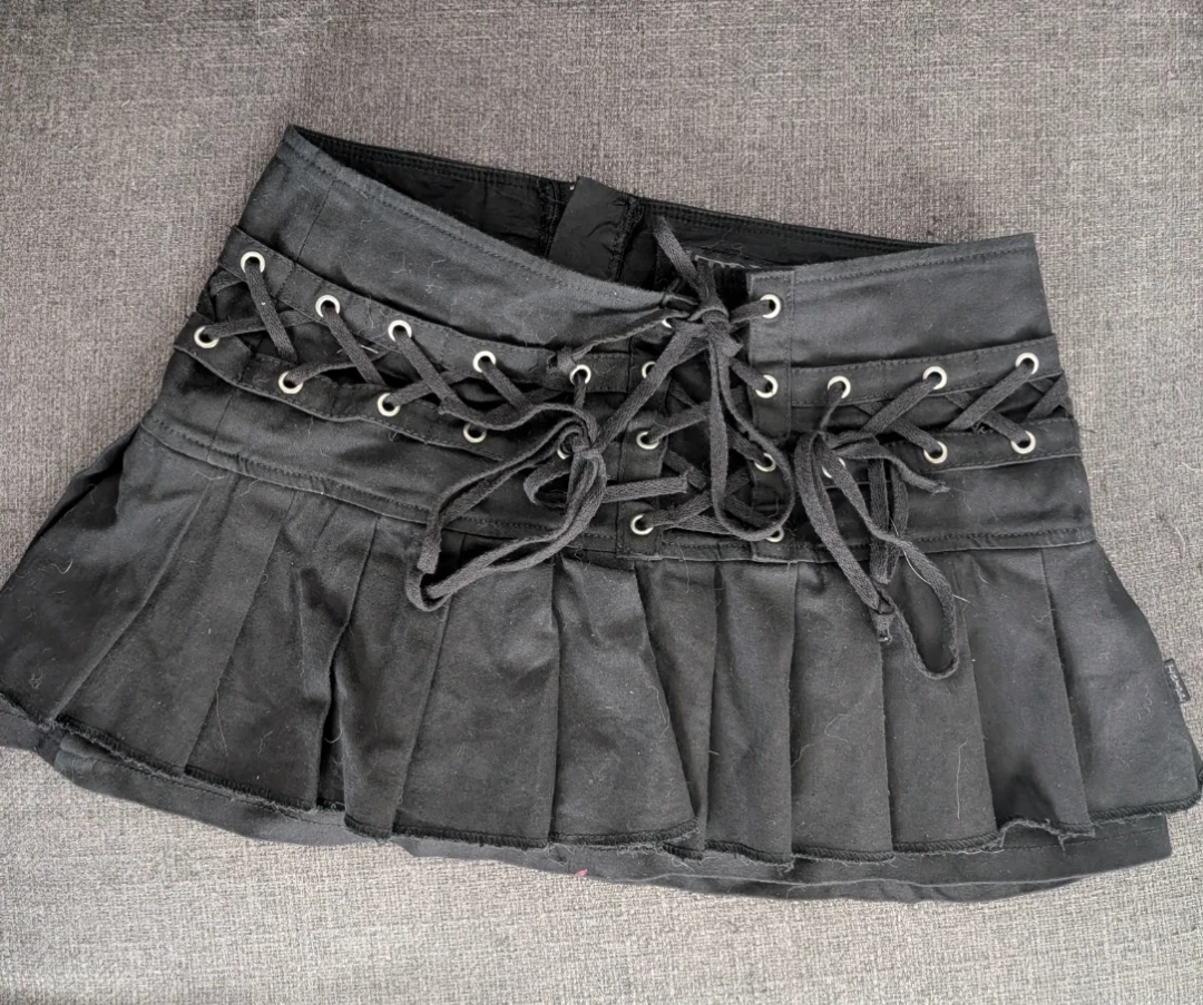 Tripp - Black Pleated Mini Skirt with Lace-Up Details