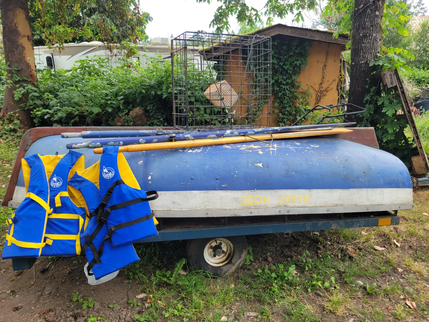 Rowboat with paddles and life jackets
