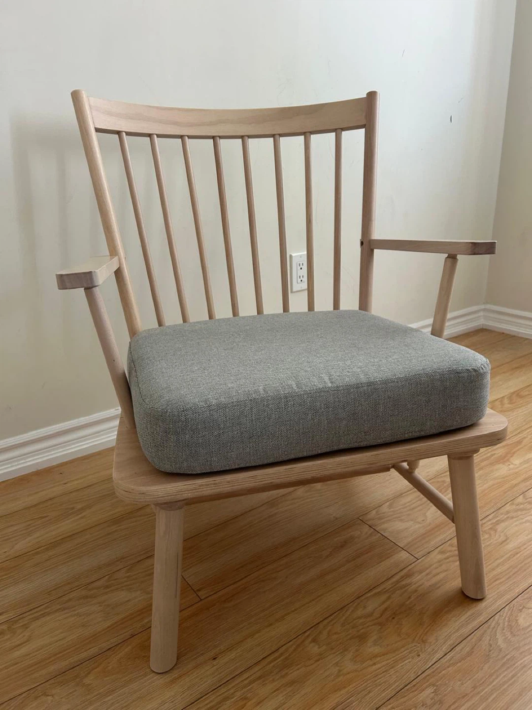 Wooden armchair with grey cushion