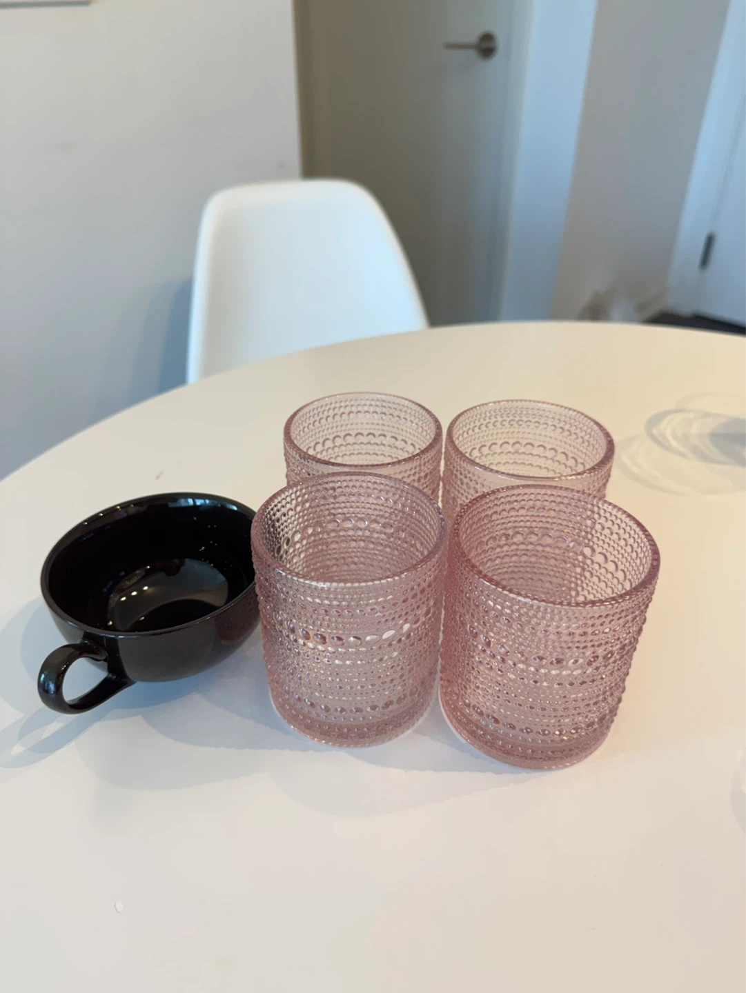 Pink glasses and brown teacup