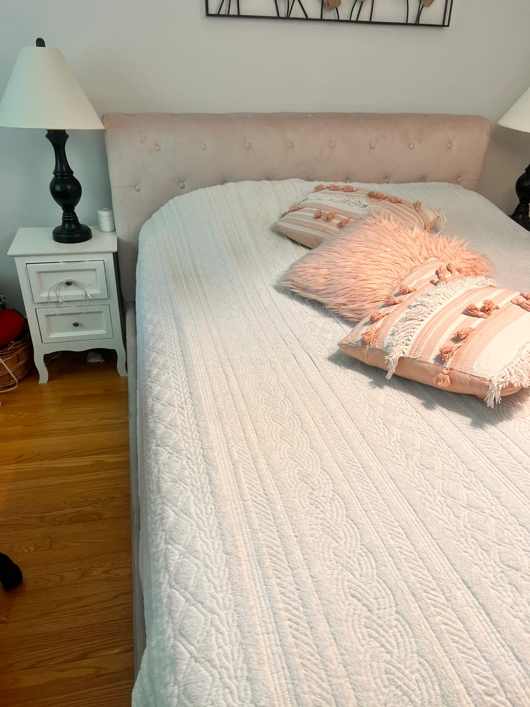 Pink velvet bed frame with two bedside tables and two lampshades