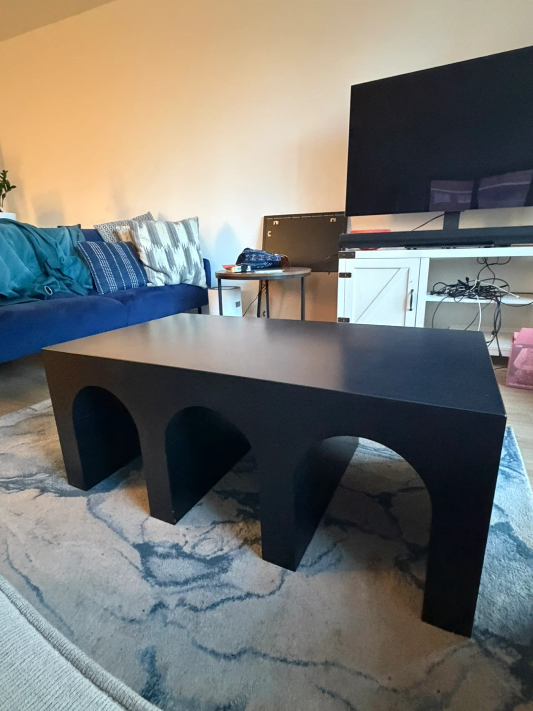 Black solid wood coffee table with arched base