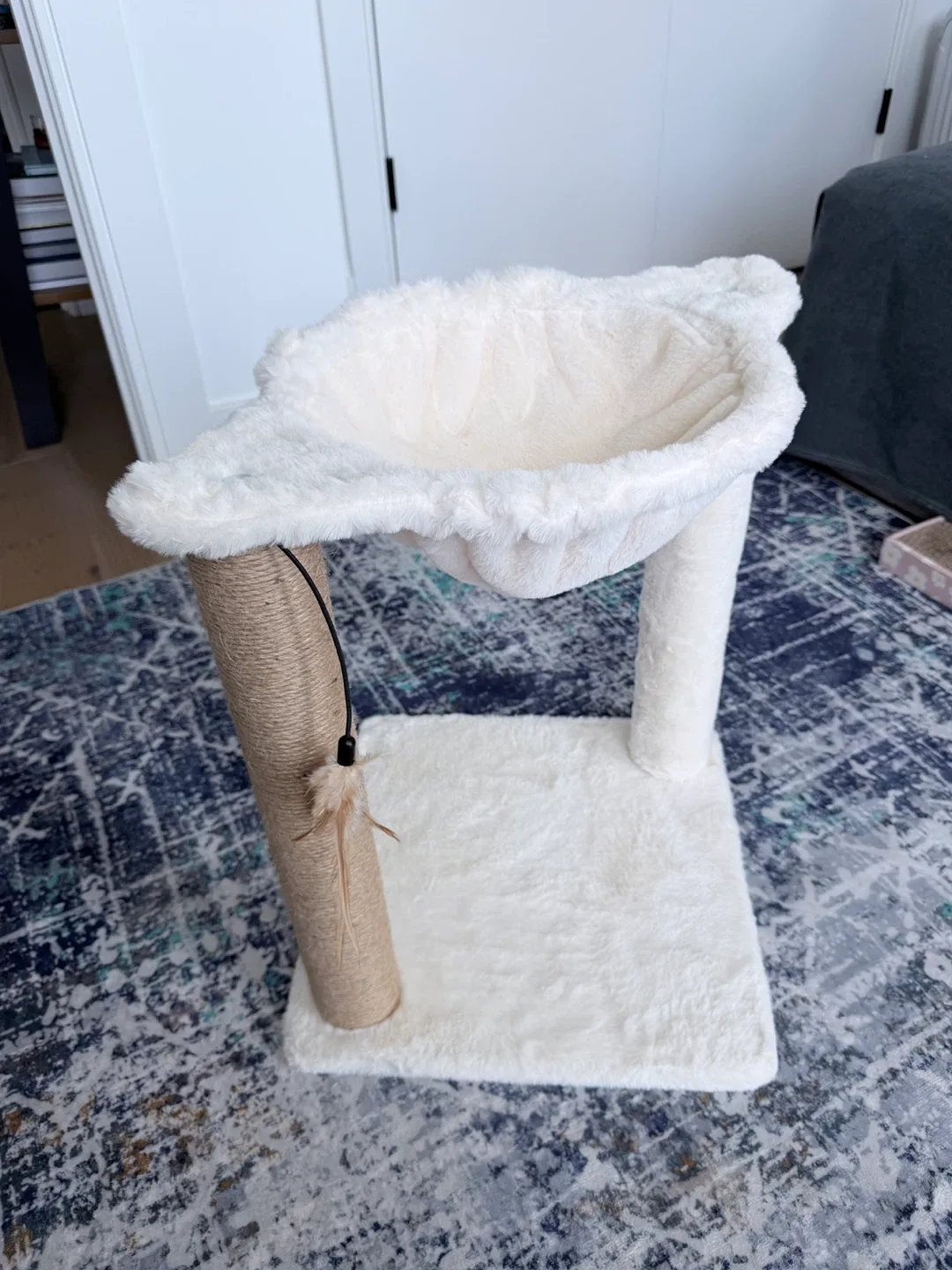 White plush cat tree with scratching post