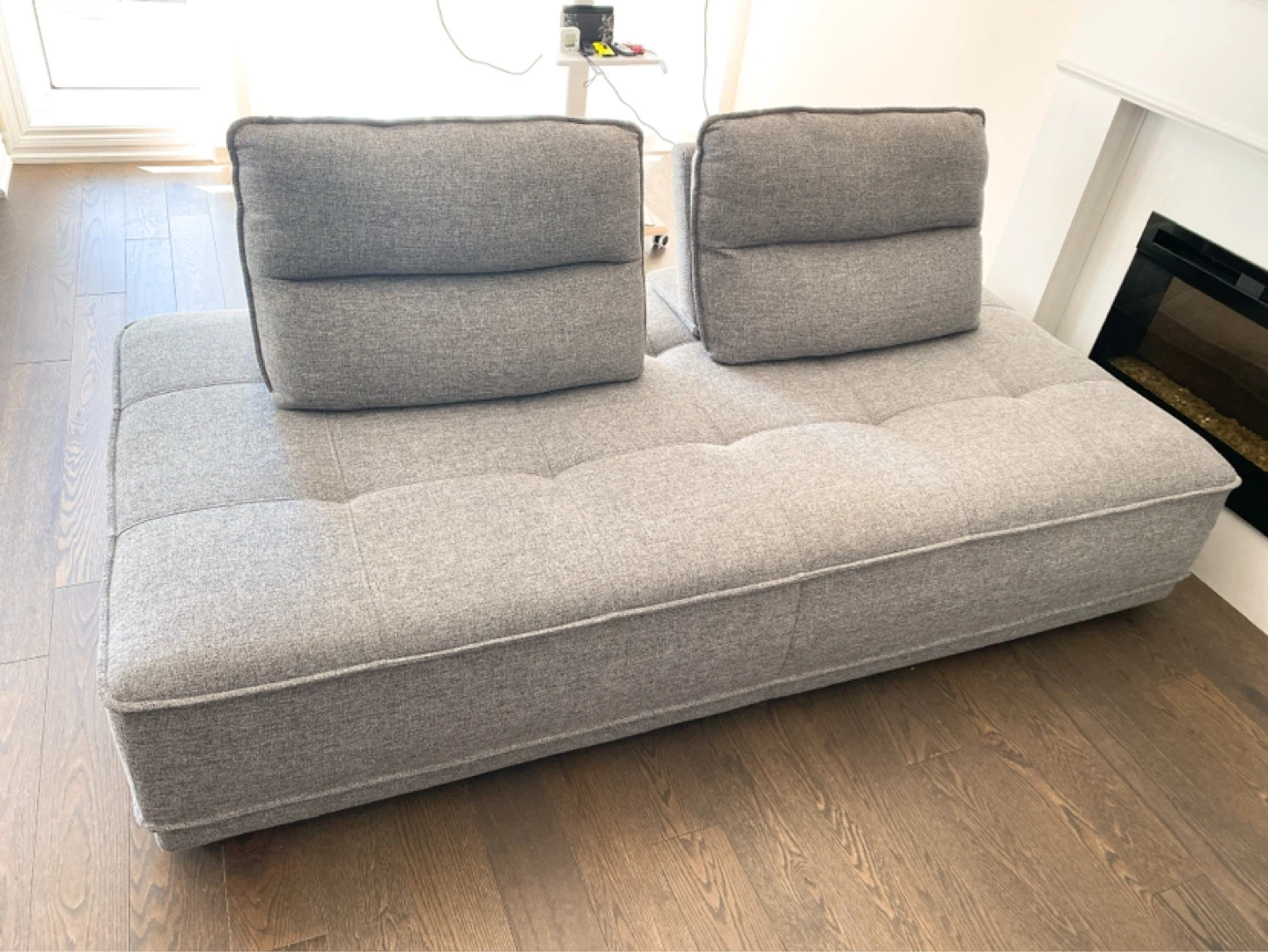 Grey upholstered daybed/sofa with two movable back cushions