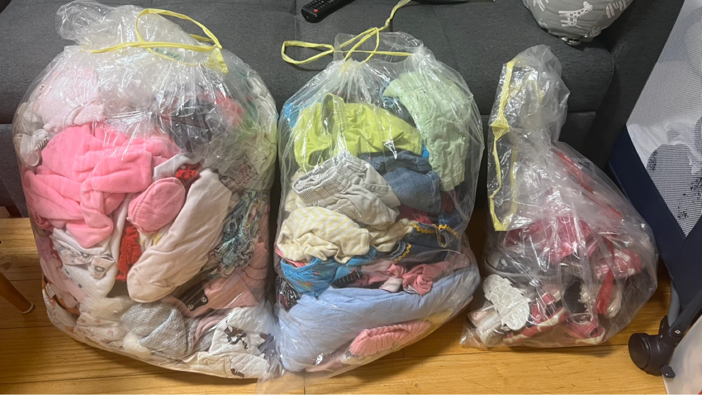 Bag of assorted baby girl clothes and shoes
