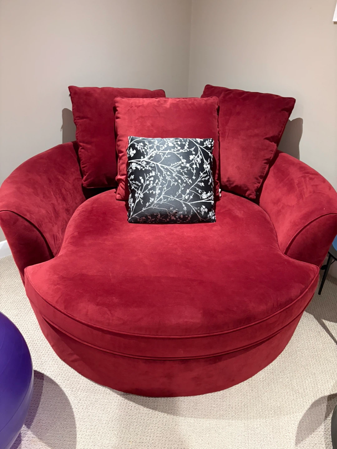 Red Suede Chair with Decorative Pillow