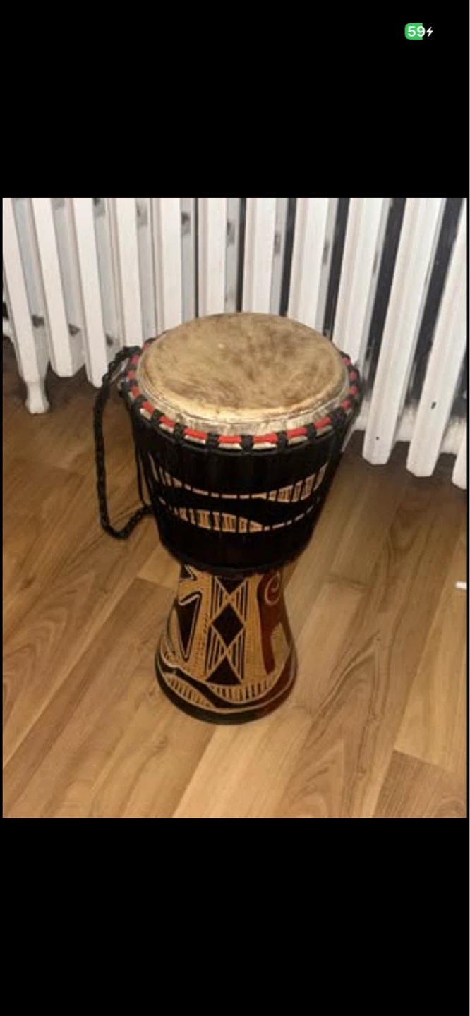 Hand-carved drum with intricate gold detailing