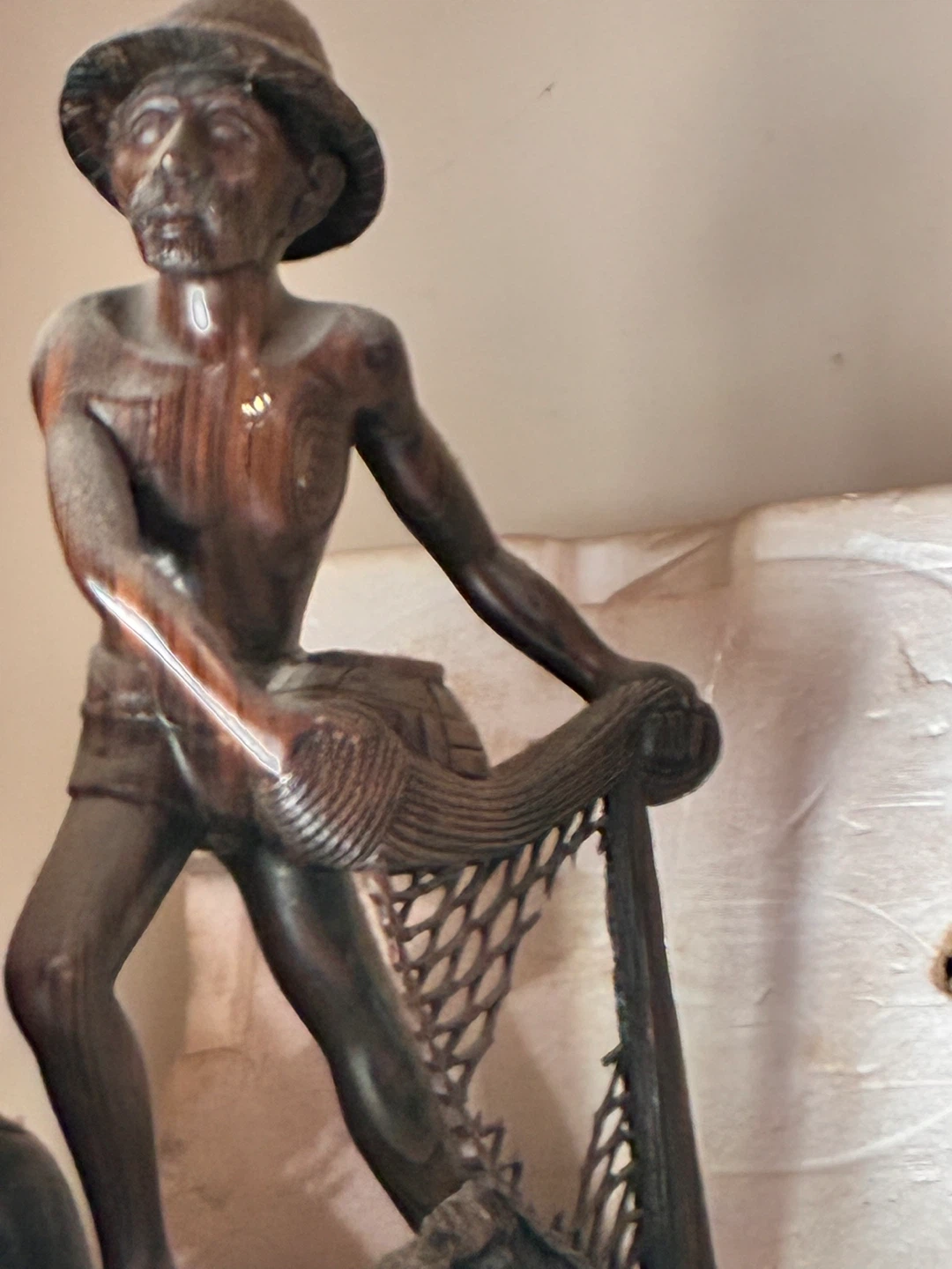 Wooden Carving of a Fisherman with Net