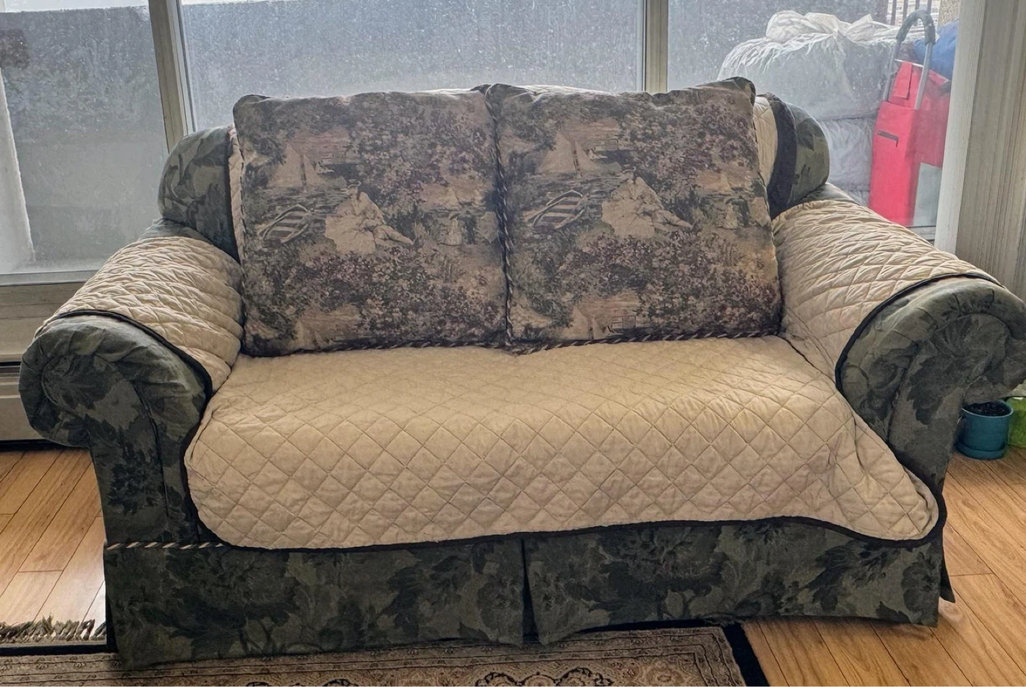 Green Floral Sofa with Patterned Throw Pillows