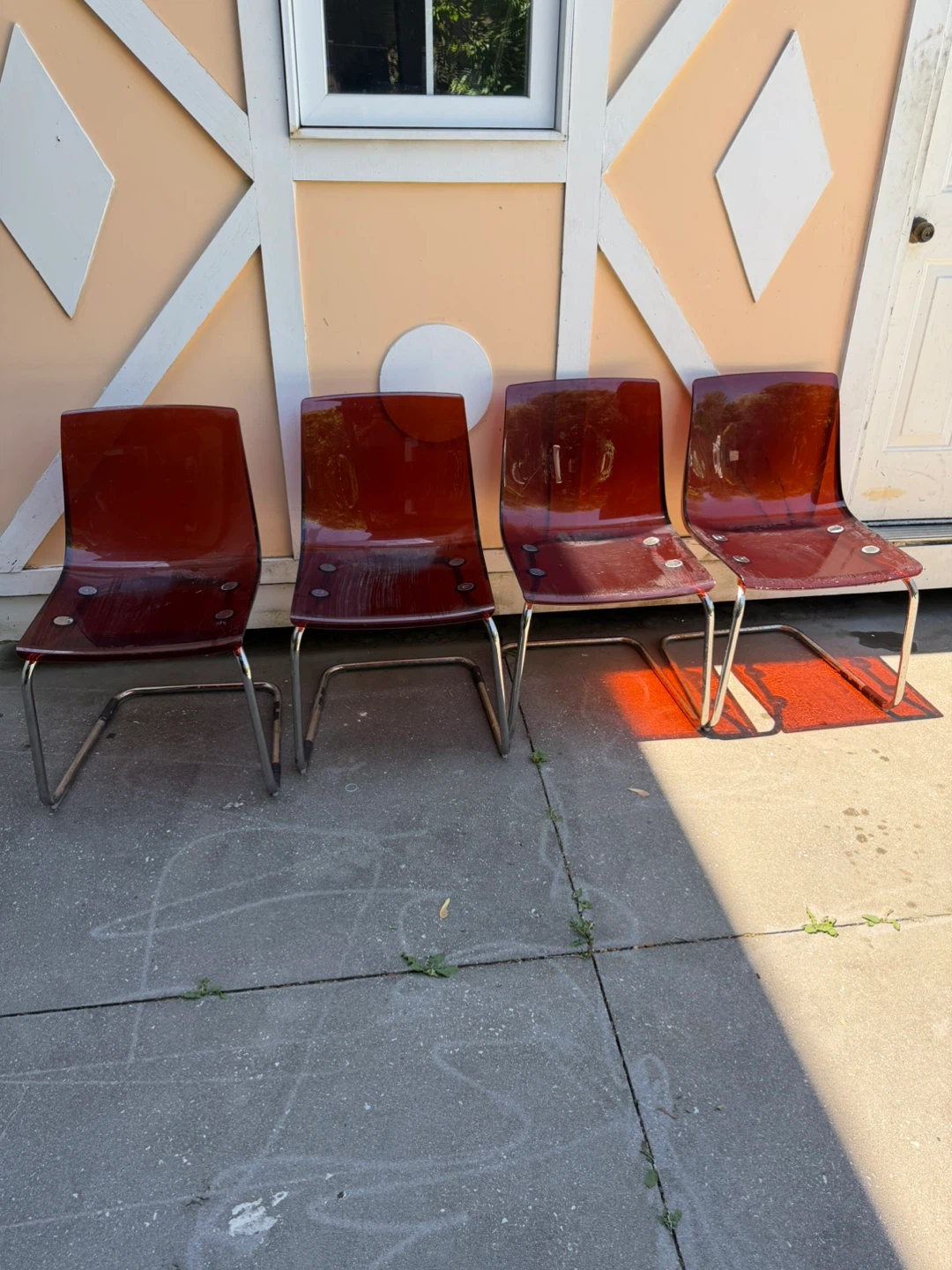 Four Red Plastic Chairs