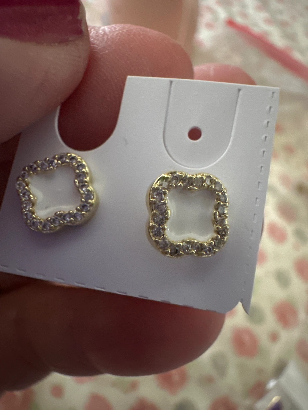 Gold laminated stud earrings with white inlay and rhinestones