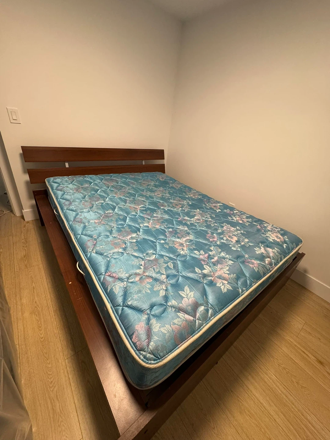 Mattress on wooden bed frame