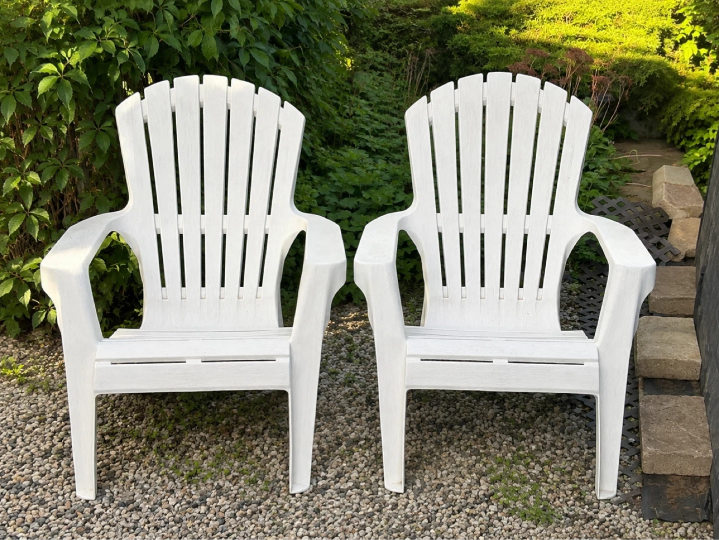 Two White Plastic Adirondack Chairs