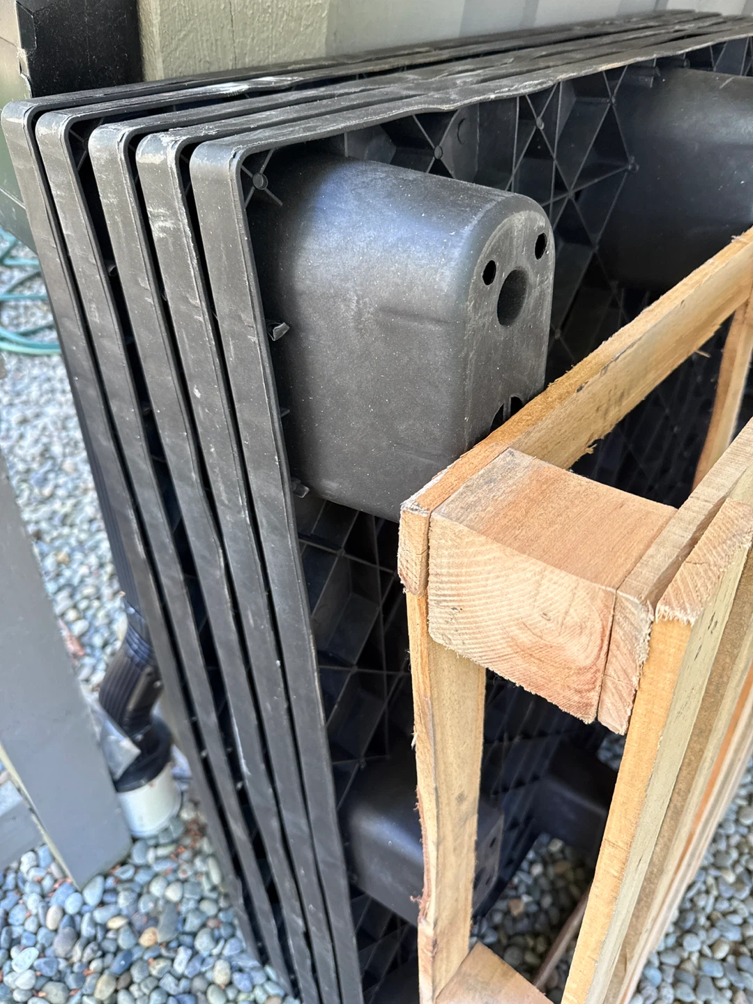 5 Stack of Black Plastic Pallets with Wooden Pallet