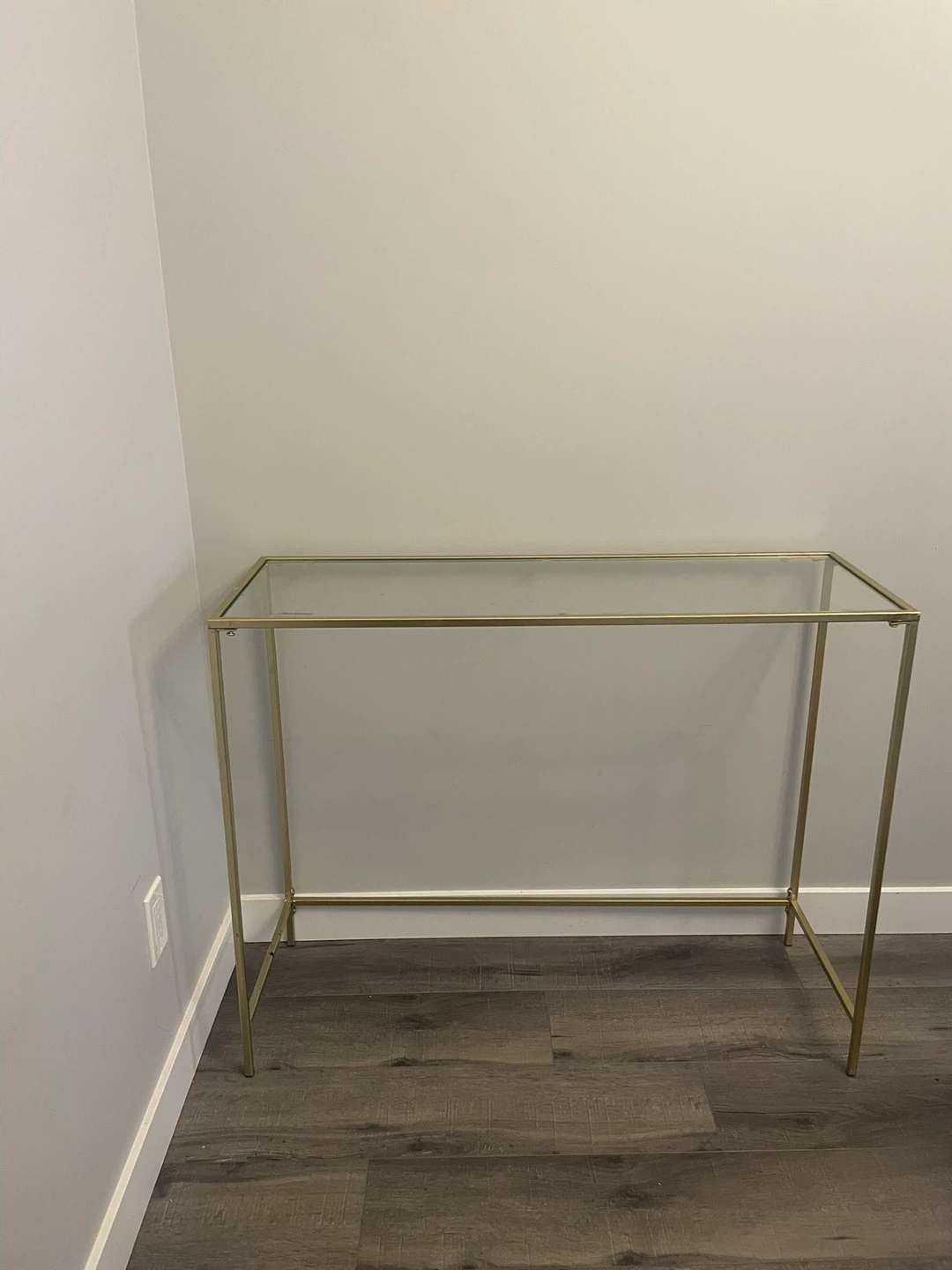 Glass top console table with gold frame