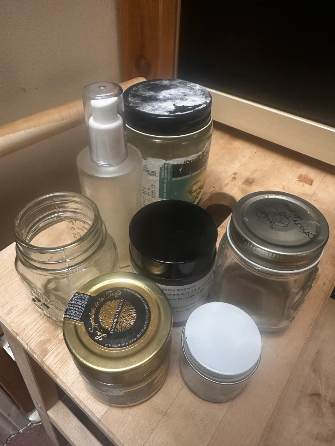 Empty glass jar and pump bottle