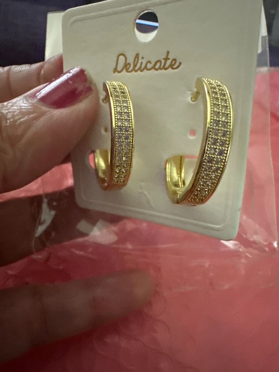 Gold tone hoop earrings with pave stones