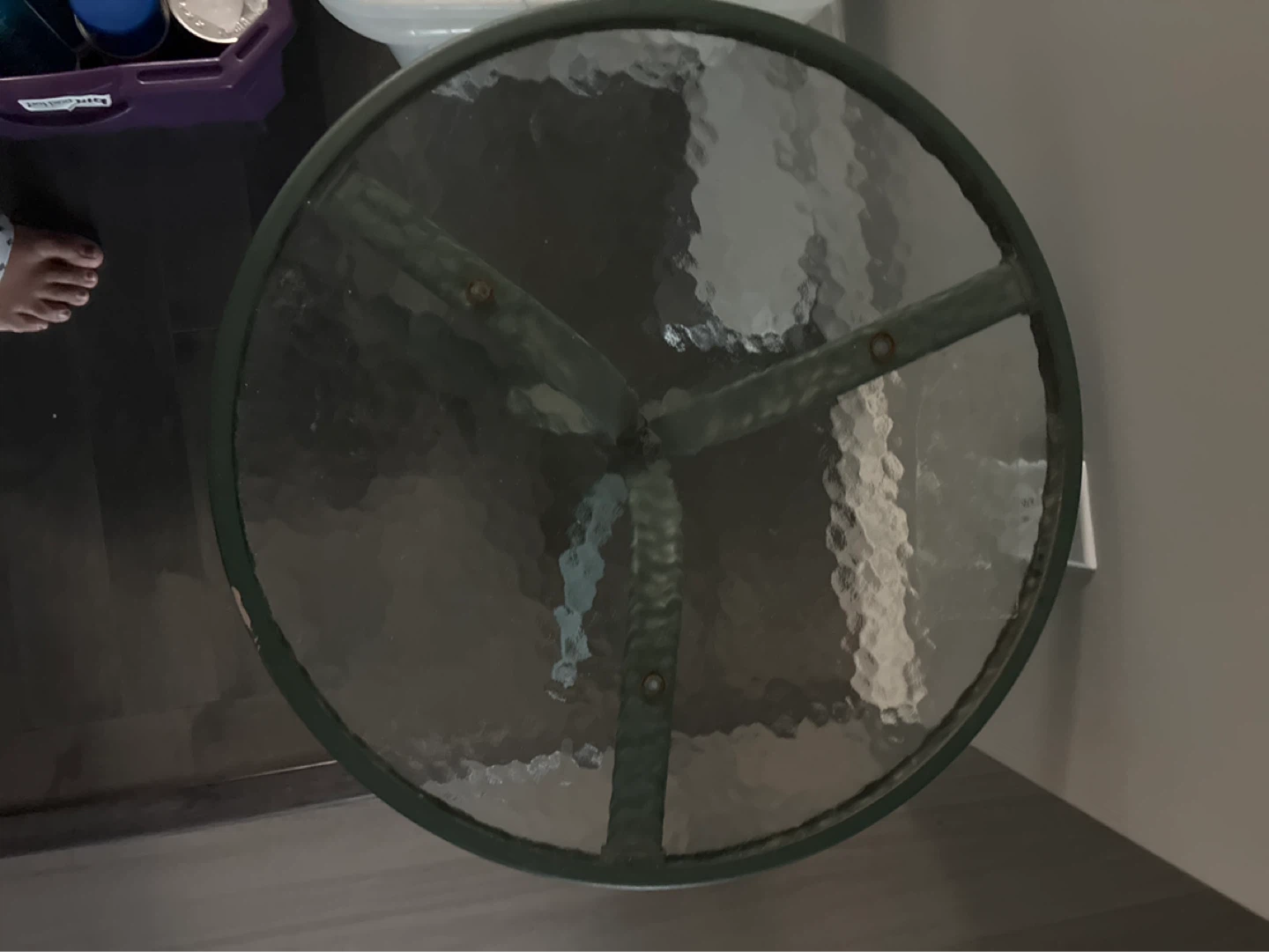 Green metal outdoor side table with glass top
