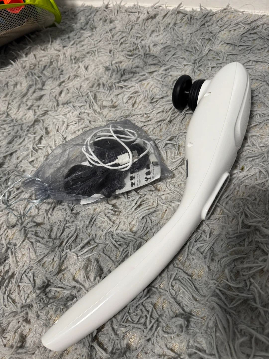 White handheld massager with attachments