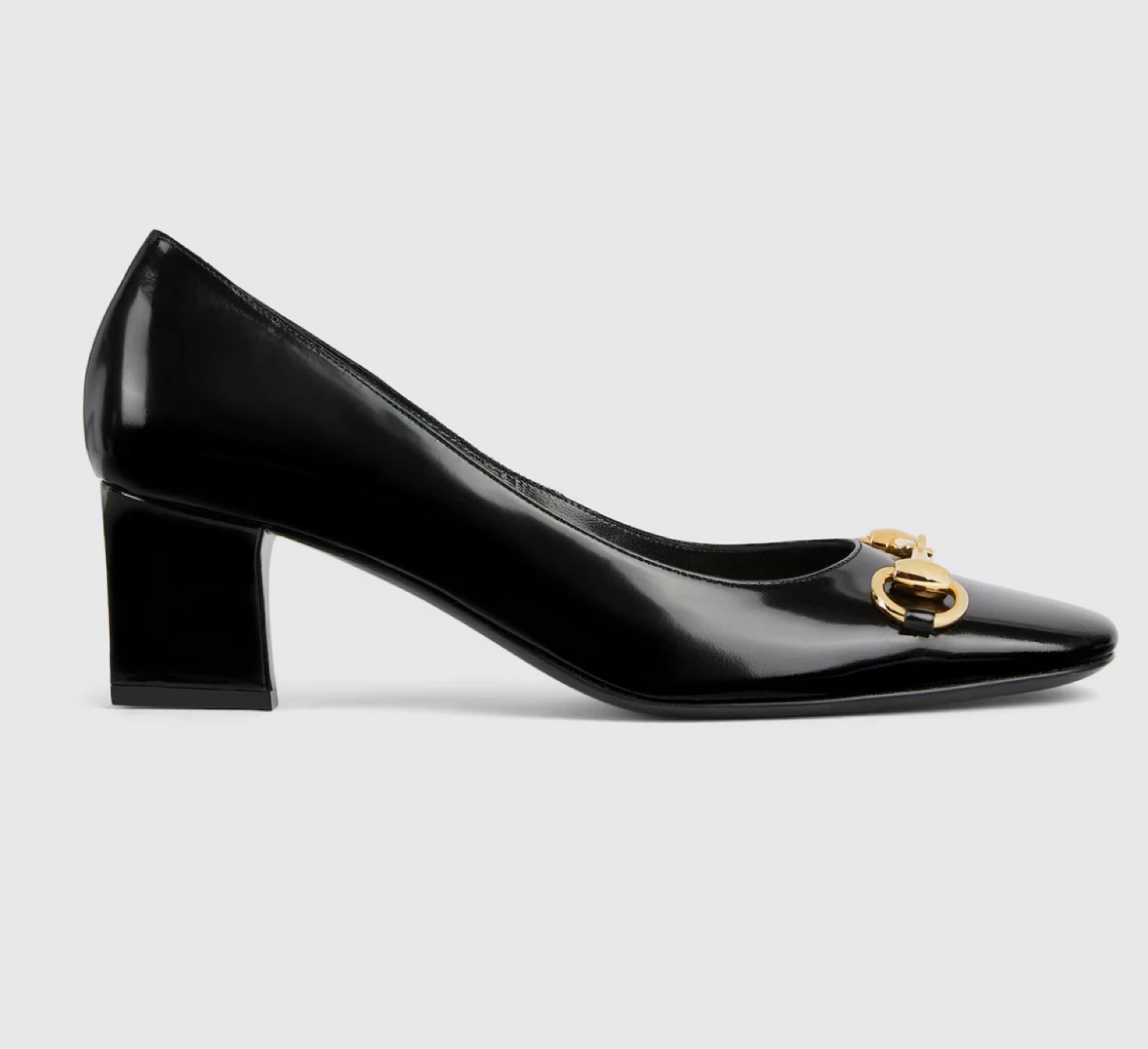 Black patent leather pumps with gold horsebit detail