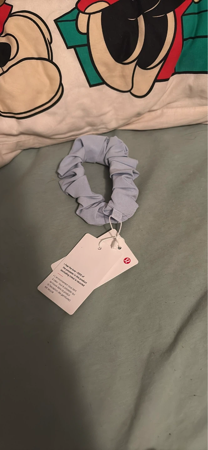Lululemon scrunchie tags on blue linen
