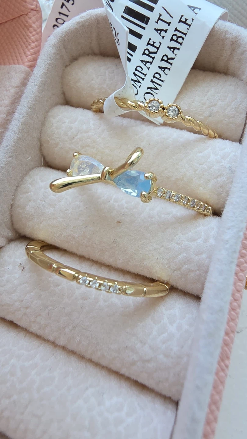 Set of 3 gold-tone rings with cubic zirconia and blue stone