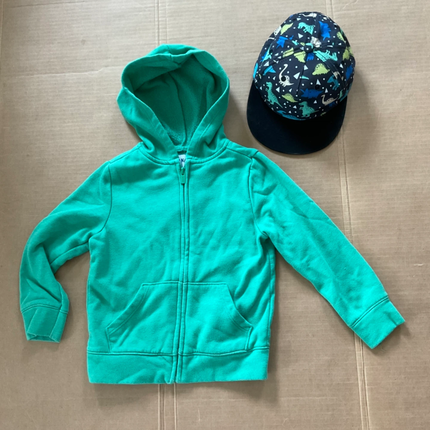 Kid’s Green zip-up hoodie and Dino cap