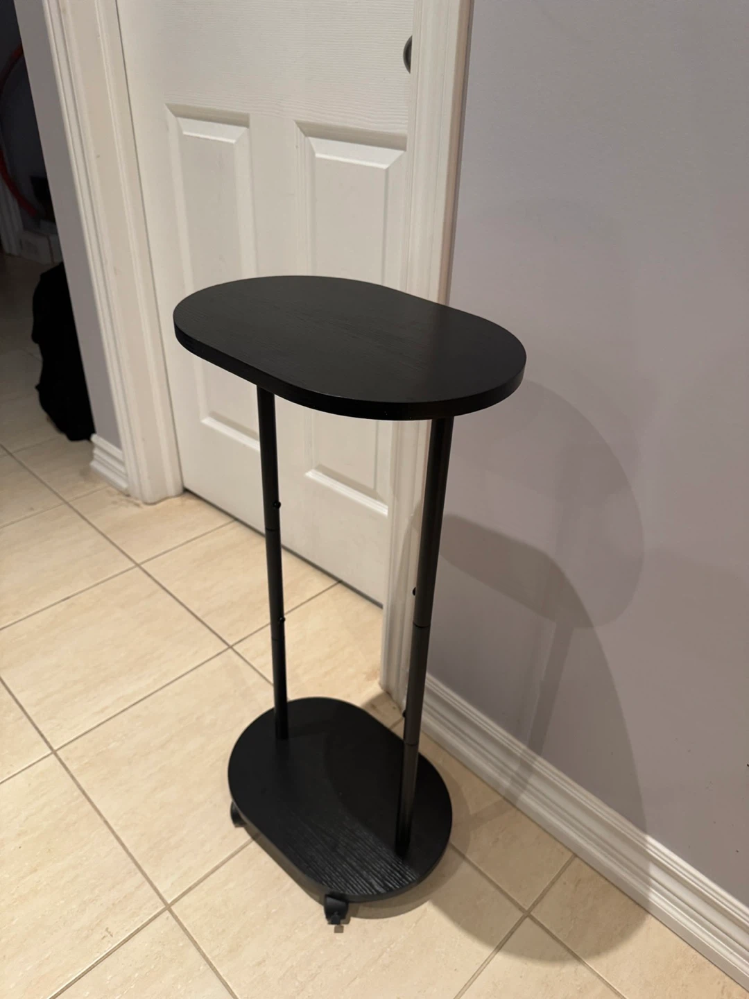 Black Oval Accent Table with Wheels - photo 2