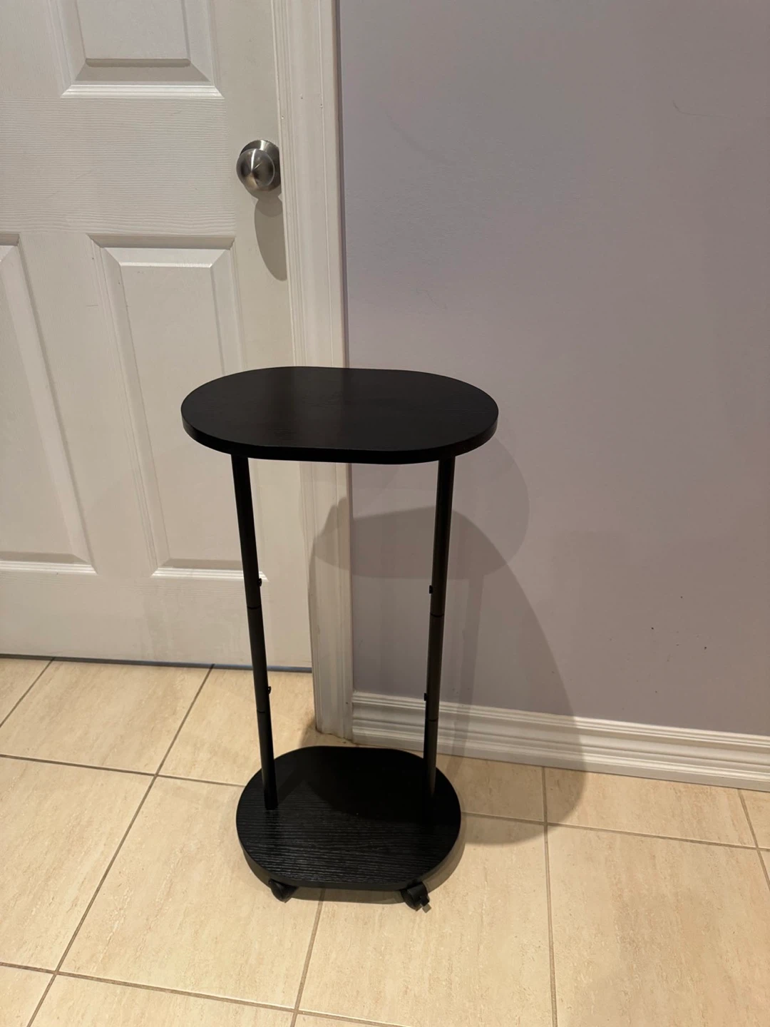 Black Oval Accent Table with Wheels