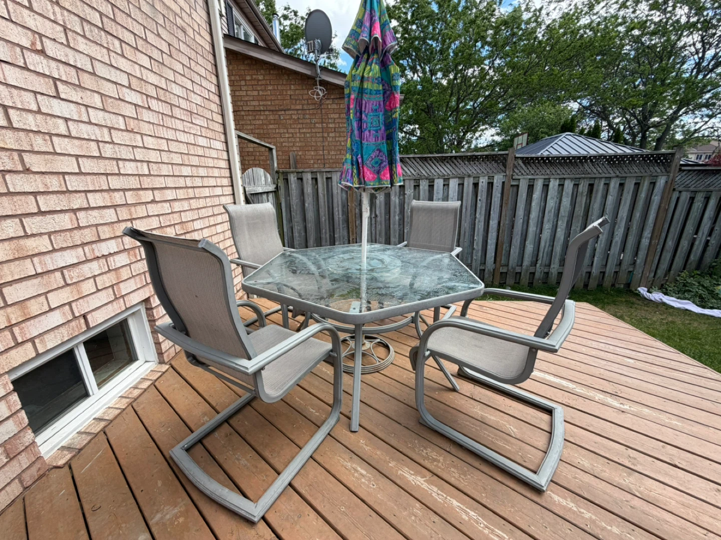 Glass patio dining set with 4 chairs and umbrella