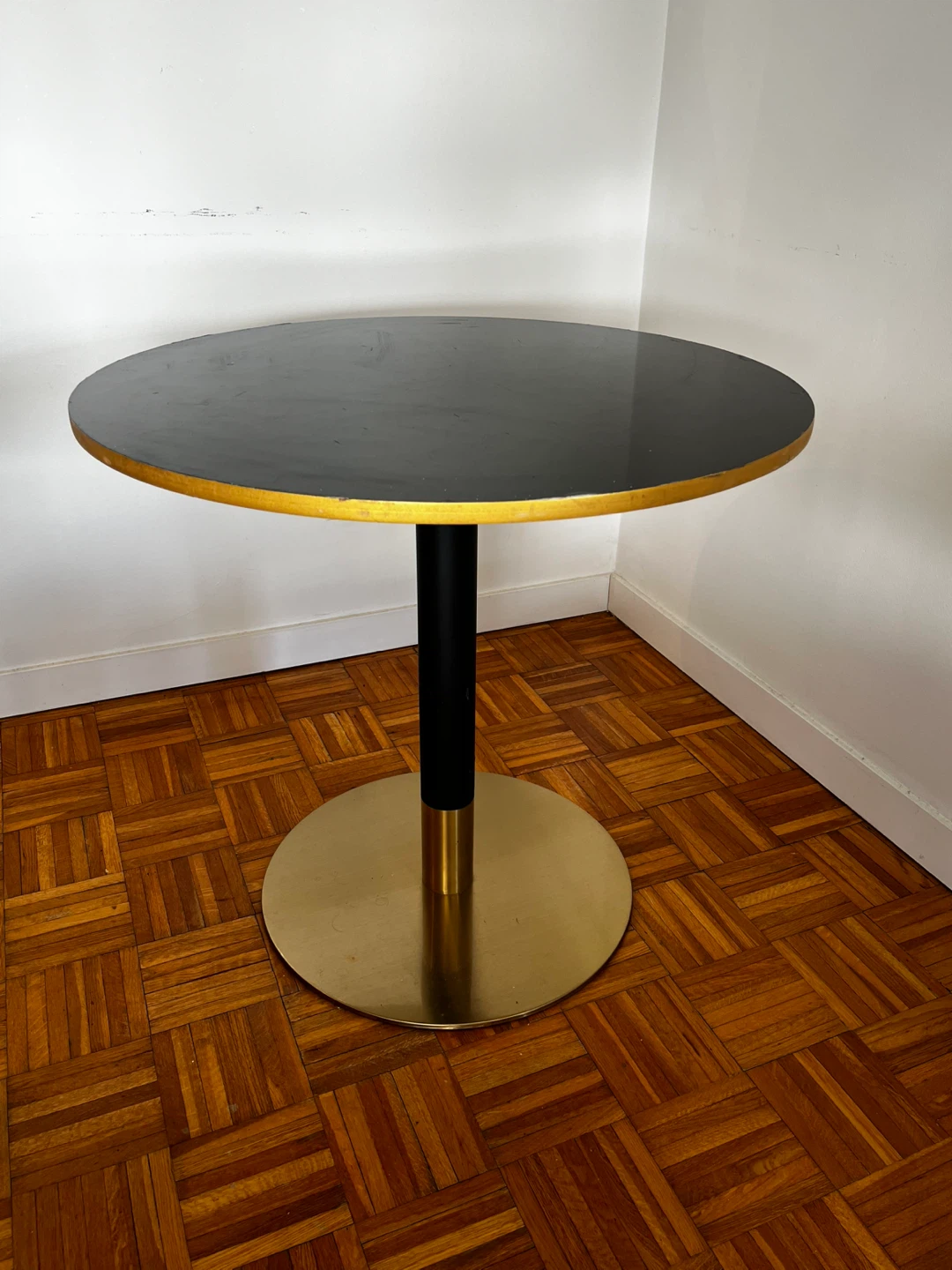 Round black dining table with gold base