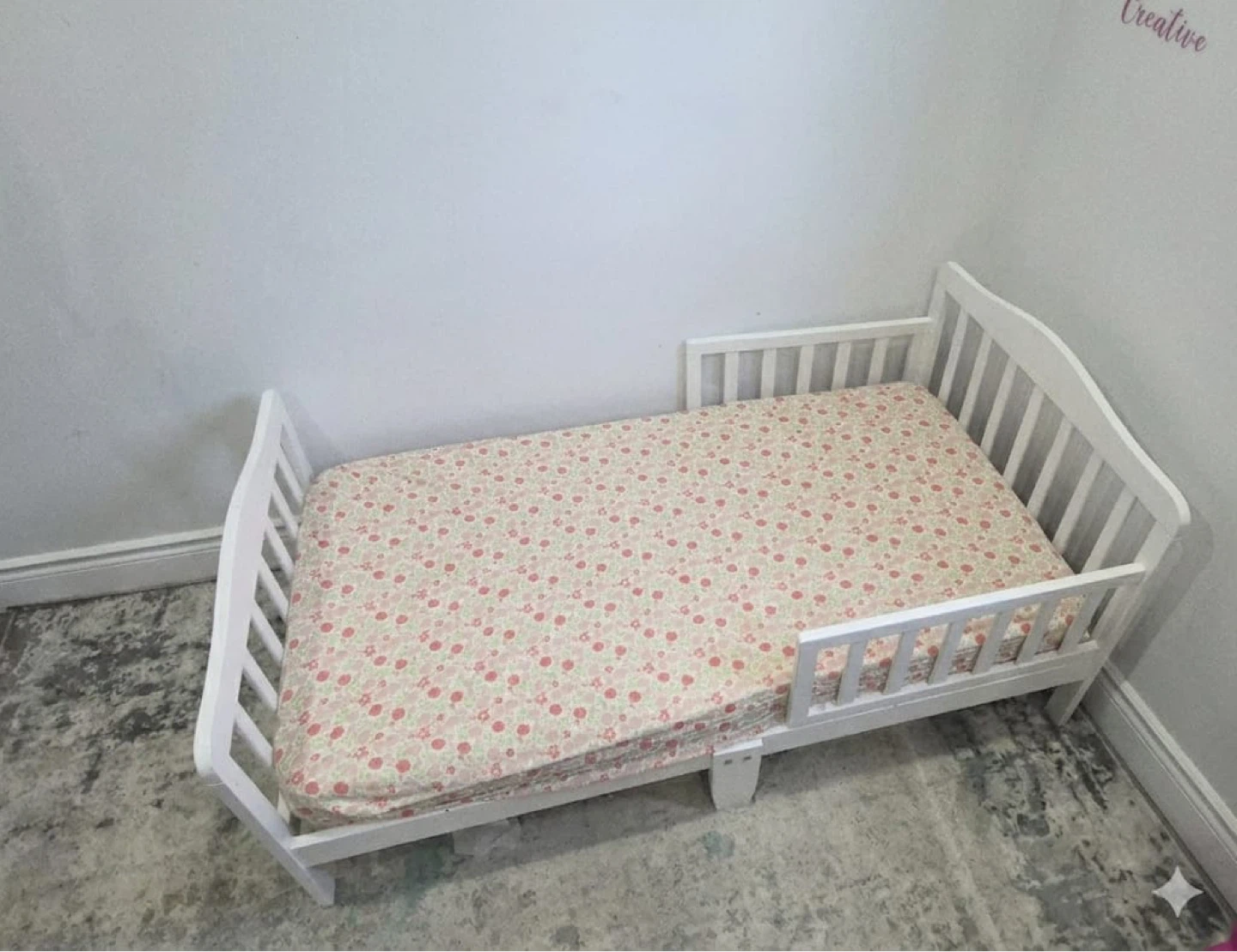 White Toddler Bed with Floral Sheet
