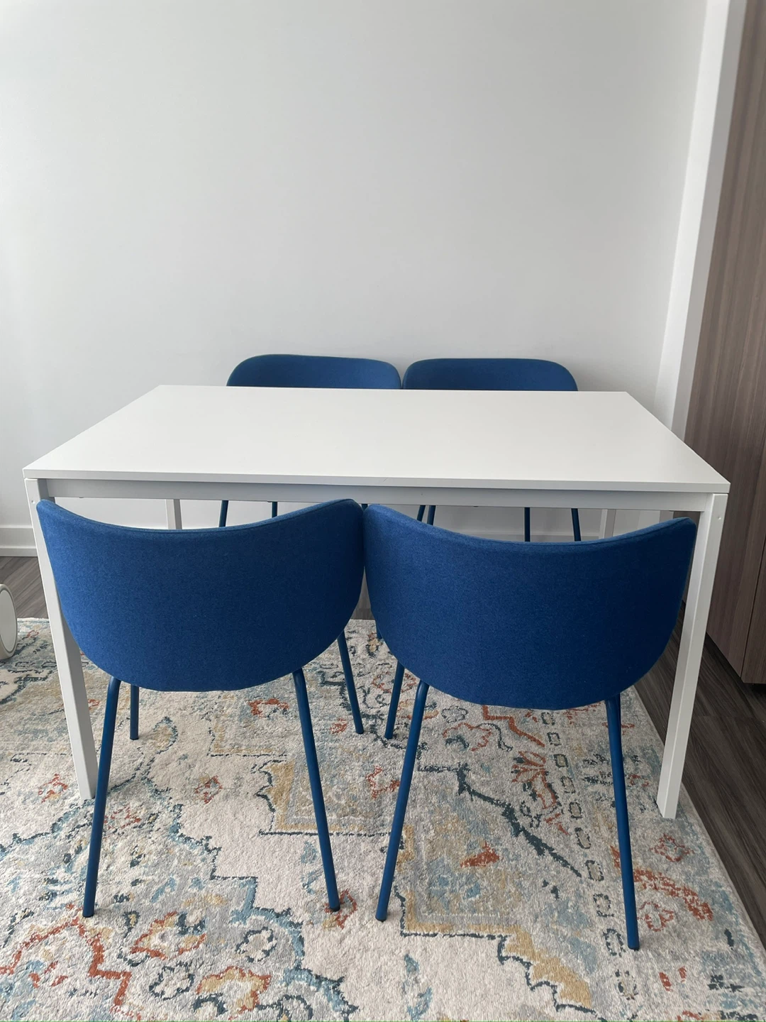White Dining Table with 4 Blue Chairs
