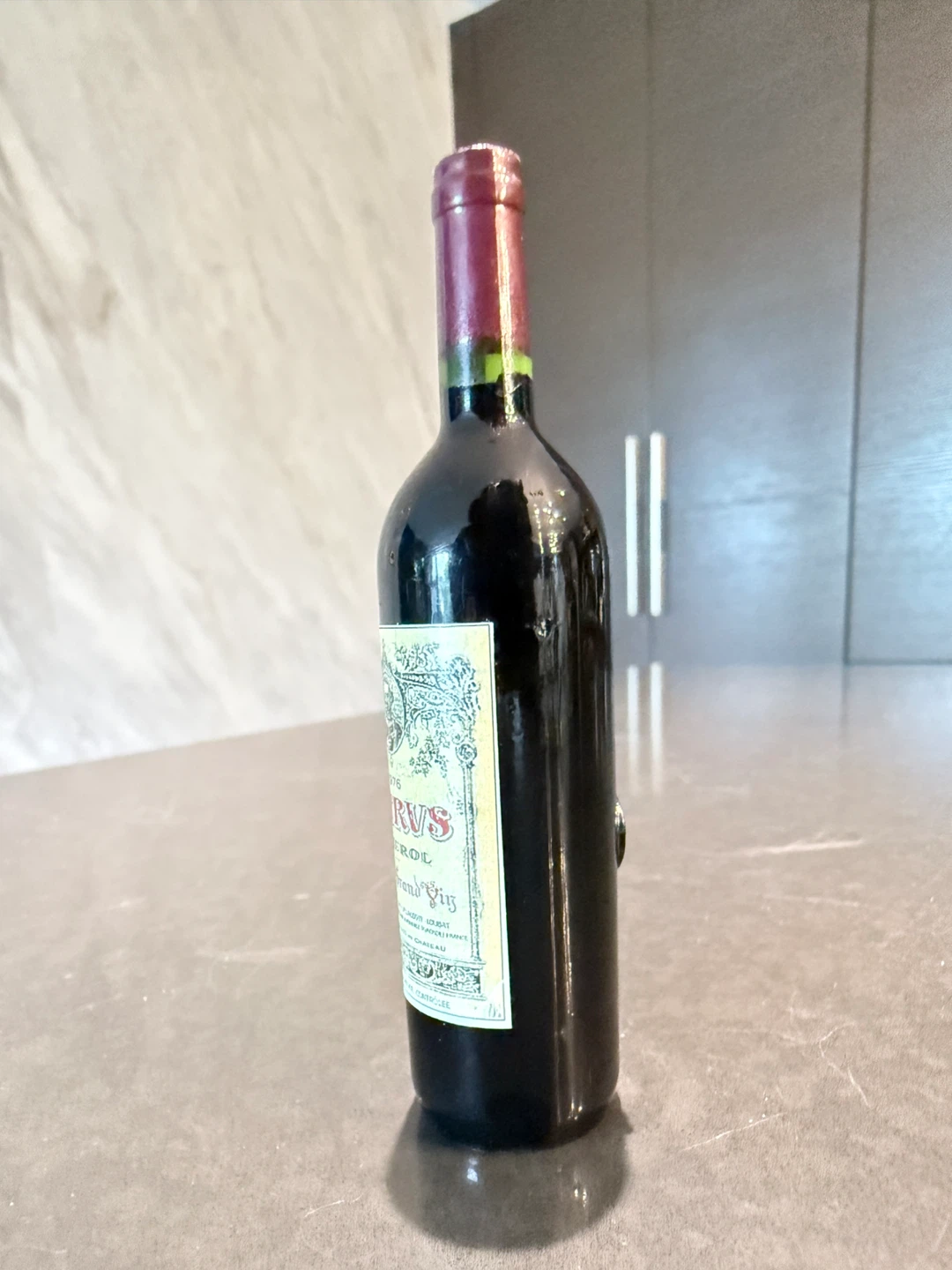 Fridge magnet feature a mini wine bottle.