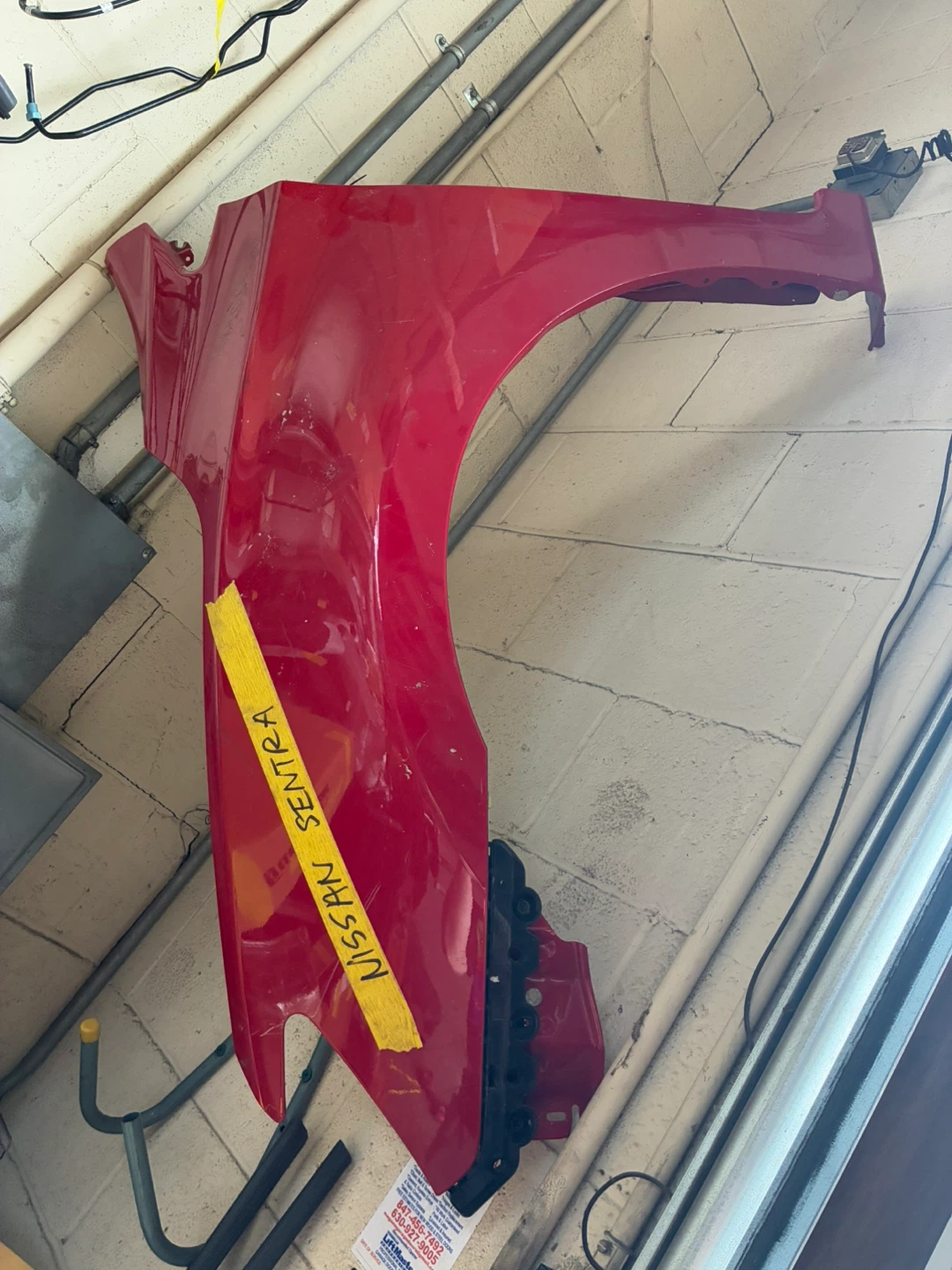 Red Nissan Sentra Fender