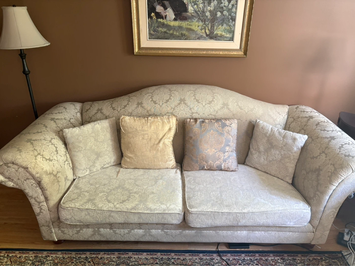 Damask upholstered sofa with two matching cushions