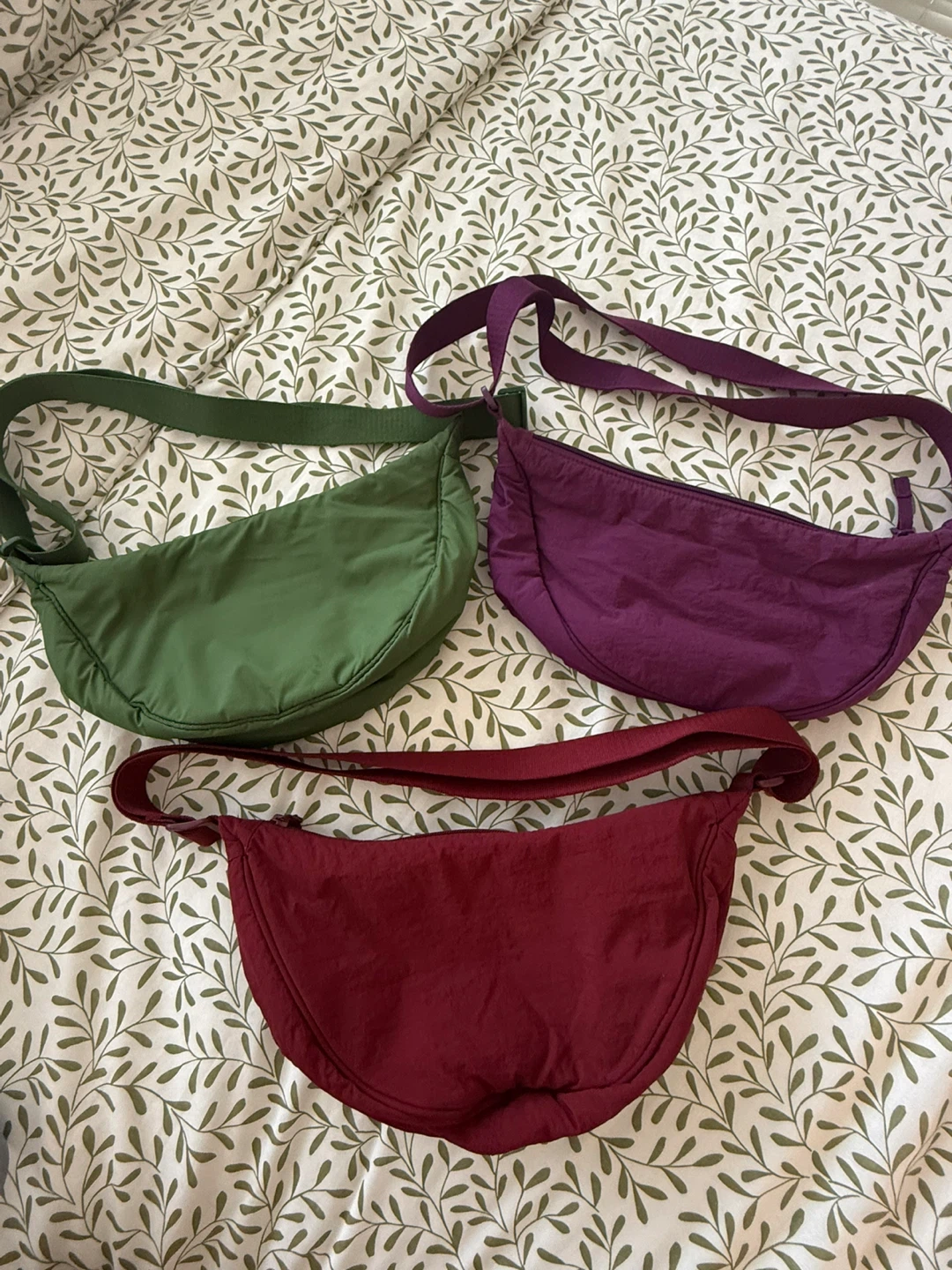 Three round mini sholder bags - green, purple, and maroon