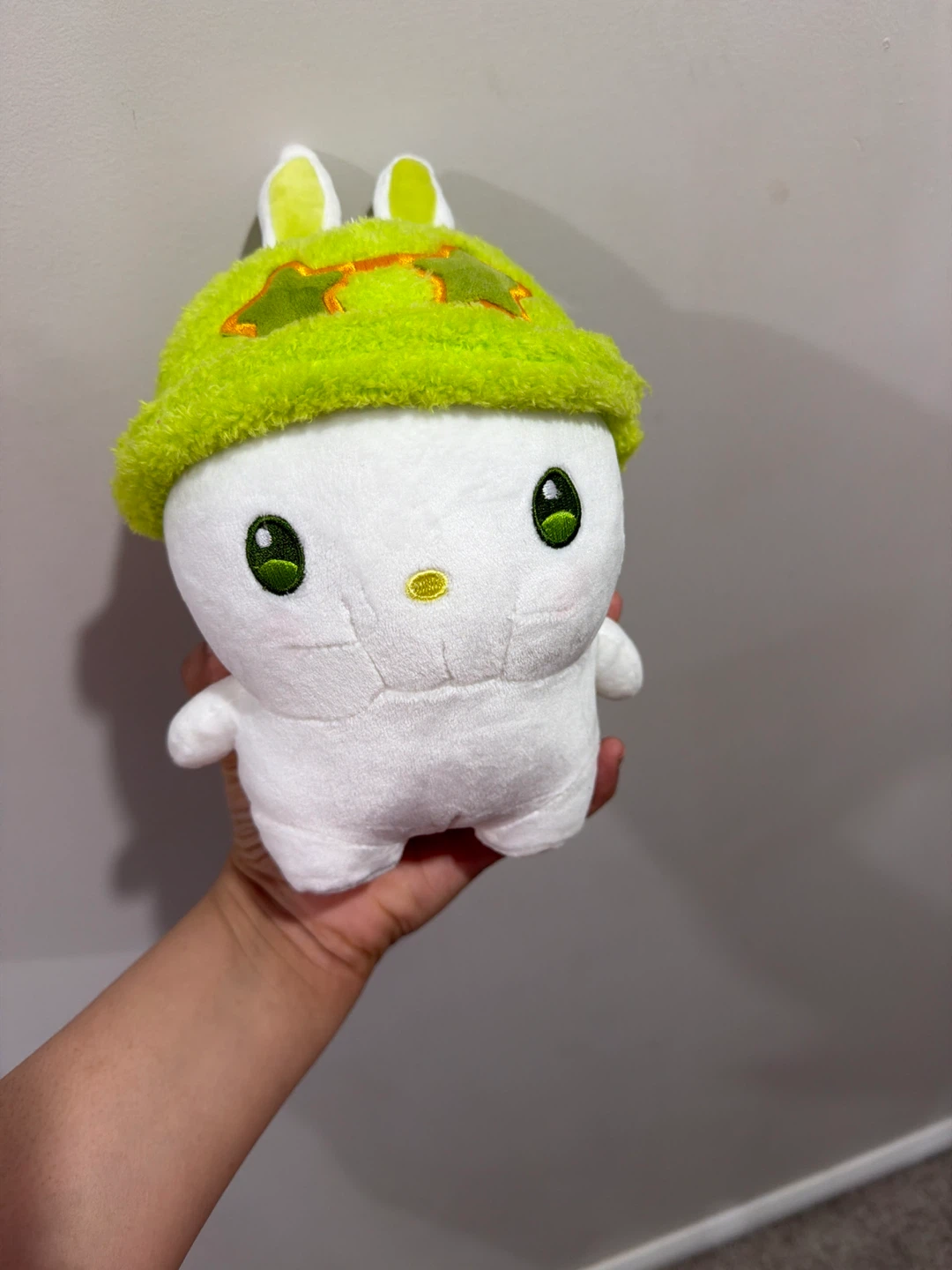 White plush toy with green hat