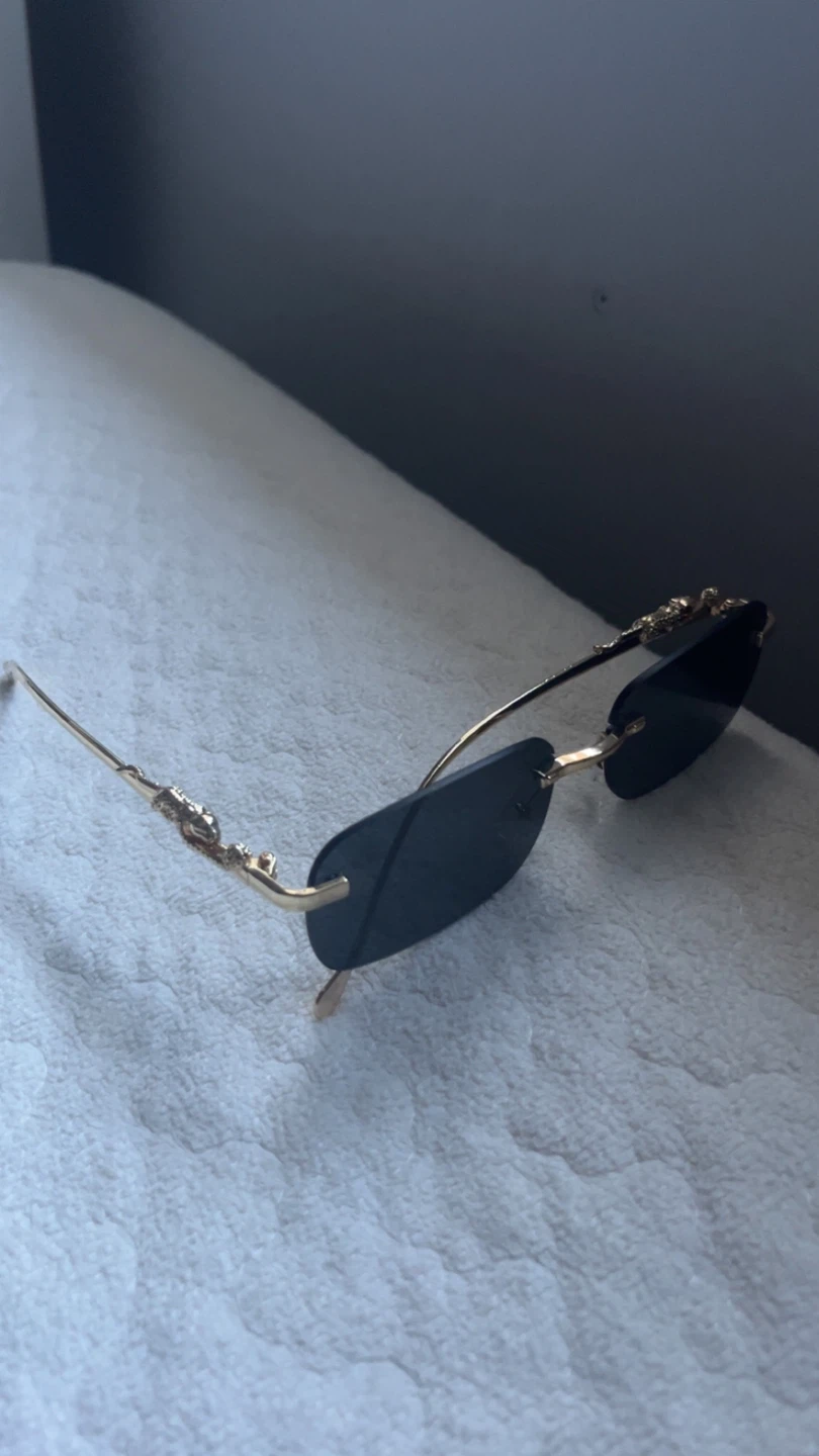 Cartier men’s and woman’s sunglasses black and gold.