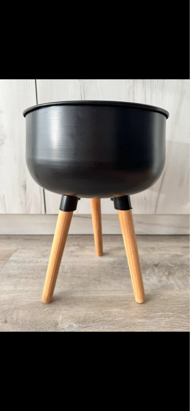 Black metal planter with wooden legs