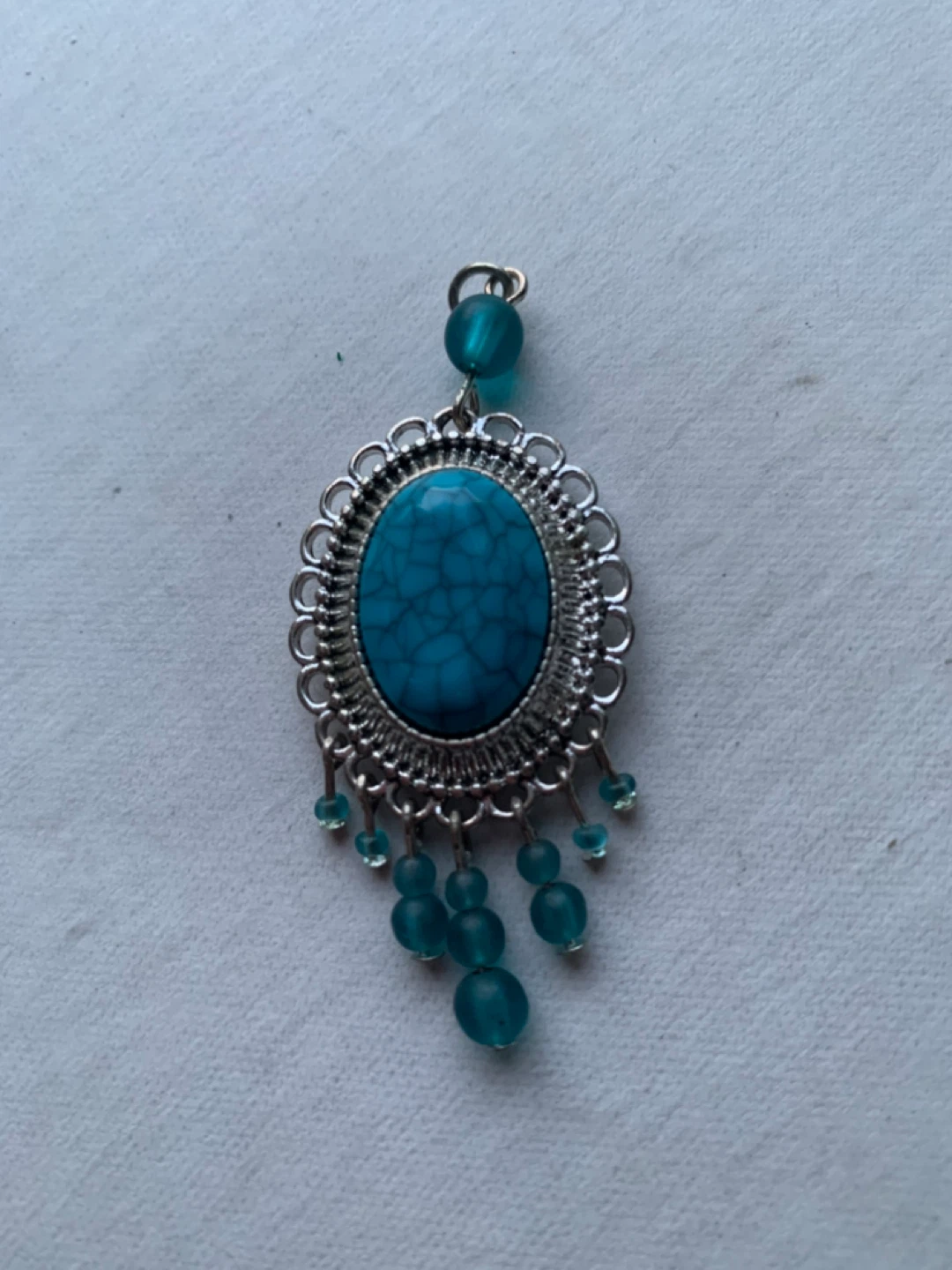 Silver-tone pendant with turquoise-style stone and beads