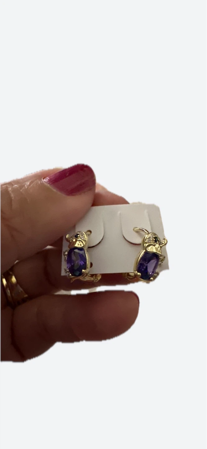 Gold laminated lil elefant’s earrings with purple stones