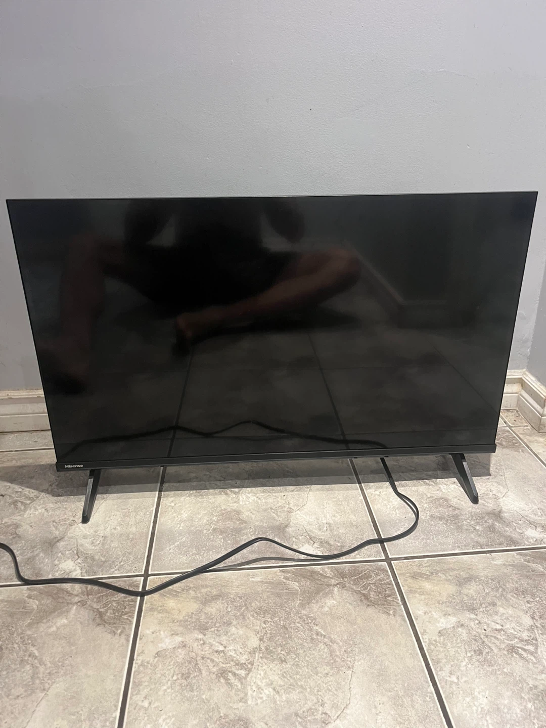 Hisense TV on white media console