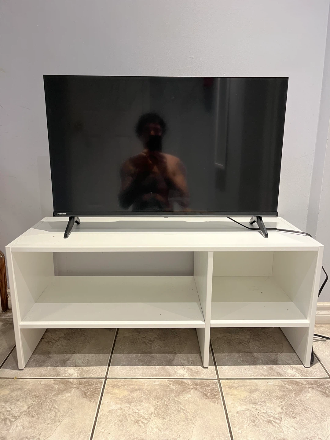 Hisense TV on white media console - photo 3