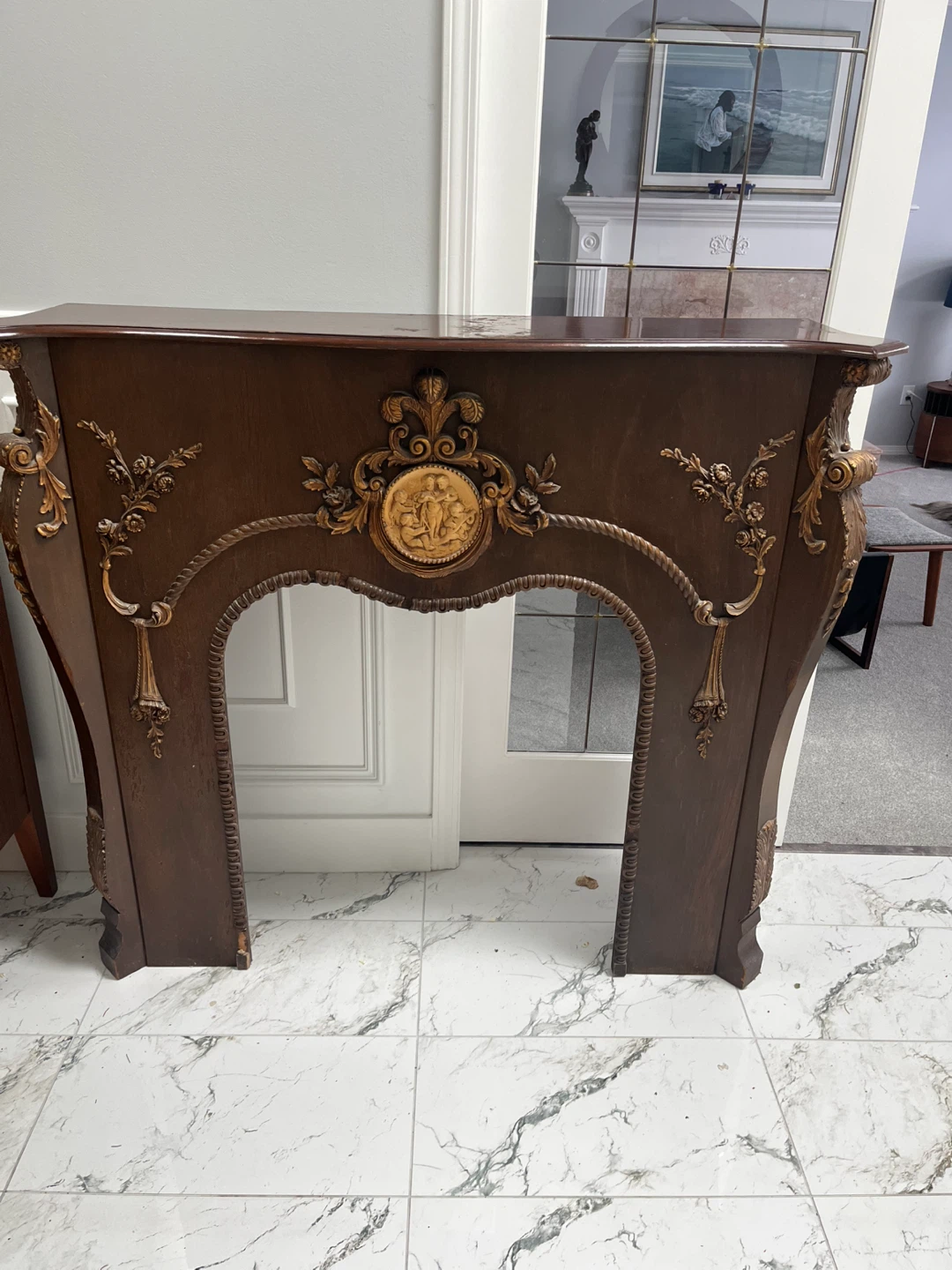 Ornate Dark Wood Fireplace Surround with Gold Accents