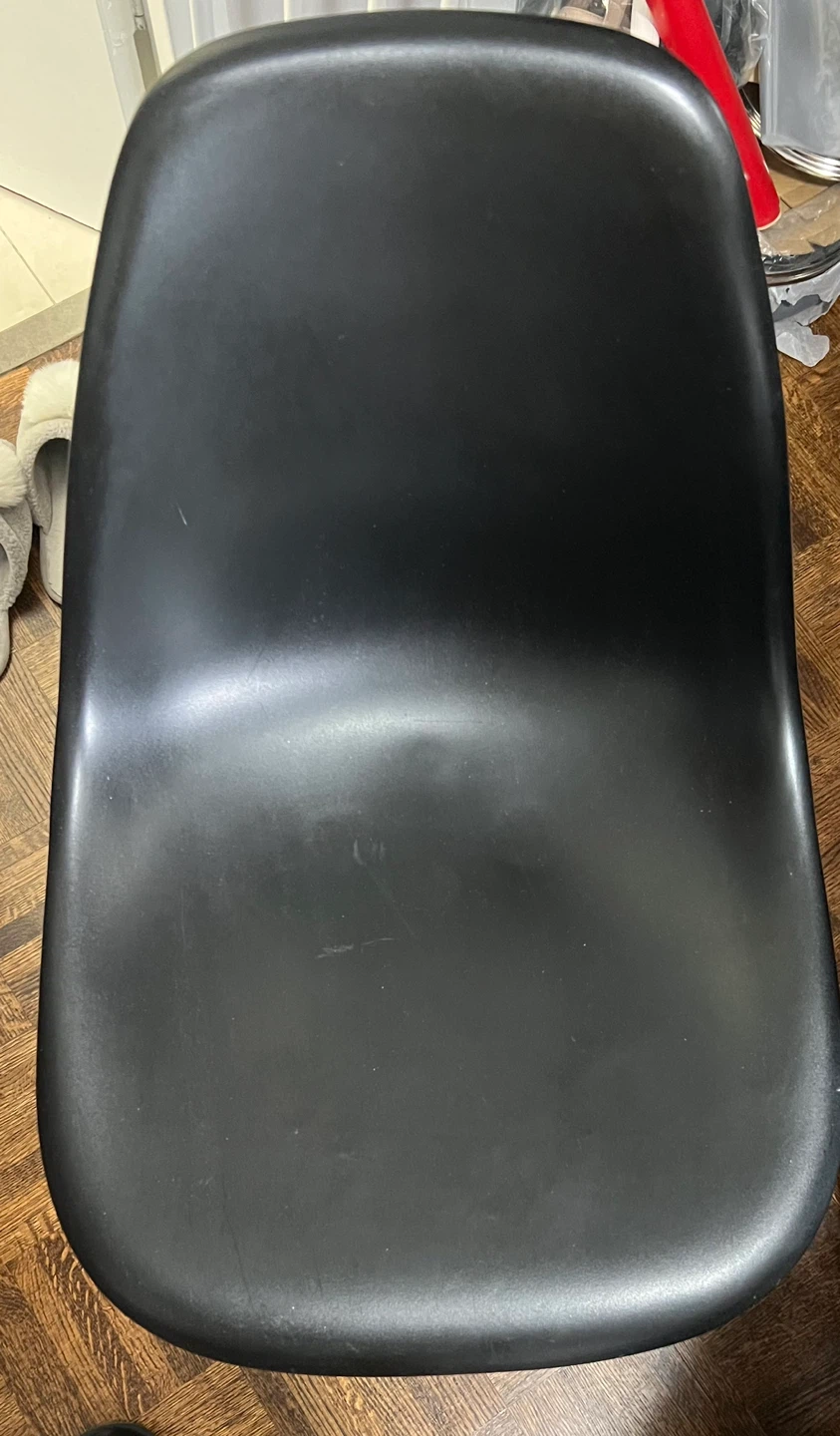 Black molded plastic chair with wooden legs