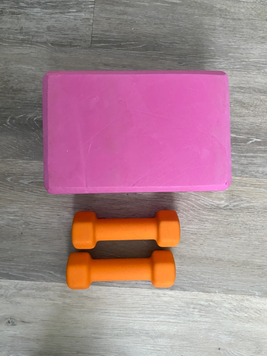 Pink Yoga Block and Orange Dumbbells