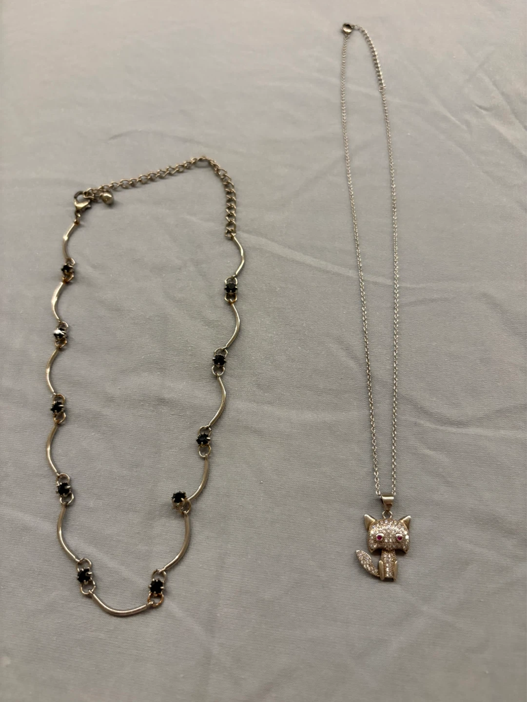 Silver-tone necklace with black stones and cat pendant necklace
